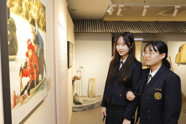 '원주 하나님의 교회'에서 열리는 ‘진심, 아버지를 읽다’展에서 '썰매' 작품을 관람 중인 학생들.